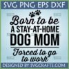 Funny 'Born to be A STAY-AT-HOME DOG MOM Forced to go to work' SVG design with paw prints, ideal for Cricut and sublimation projects.
