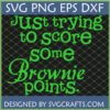A bright green text design on a dark grid background that reads "Just trying to score some Brownie points." The text includes a mix of script and serif fonts. This is a Funny Brownie Points SVG design from SVGCrafts.