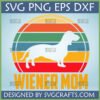 Retro Wiener Mom SVG and PNG digital design featuring a dachshund silhouette against a vintage striped sunset, ideal for Cricut and sublimation crafts.